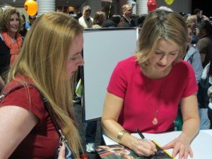 Samantha Brown signing an autograph for Dani