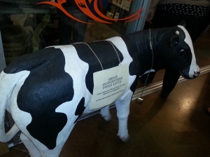 Awesome cow by the cheese shop