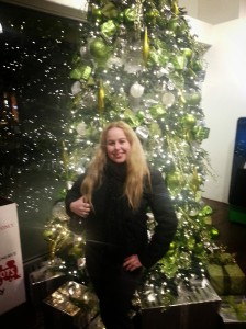 Dani in front of Christmas tree in OC Mix